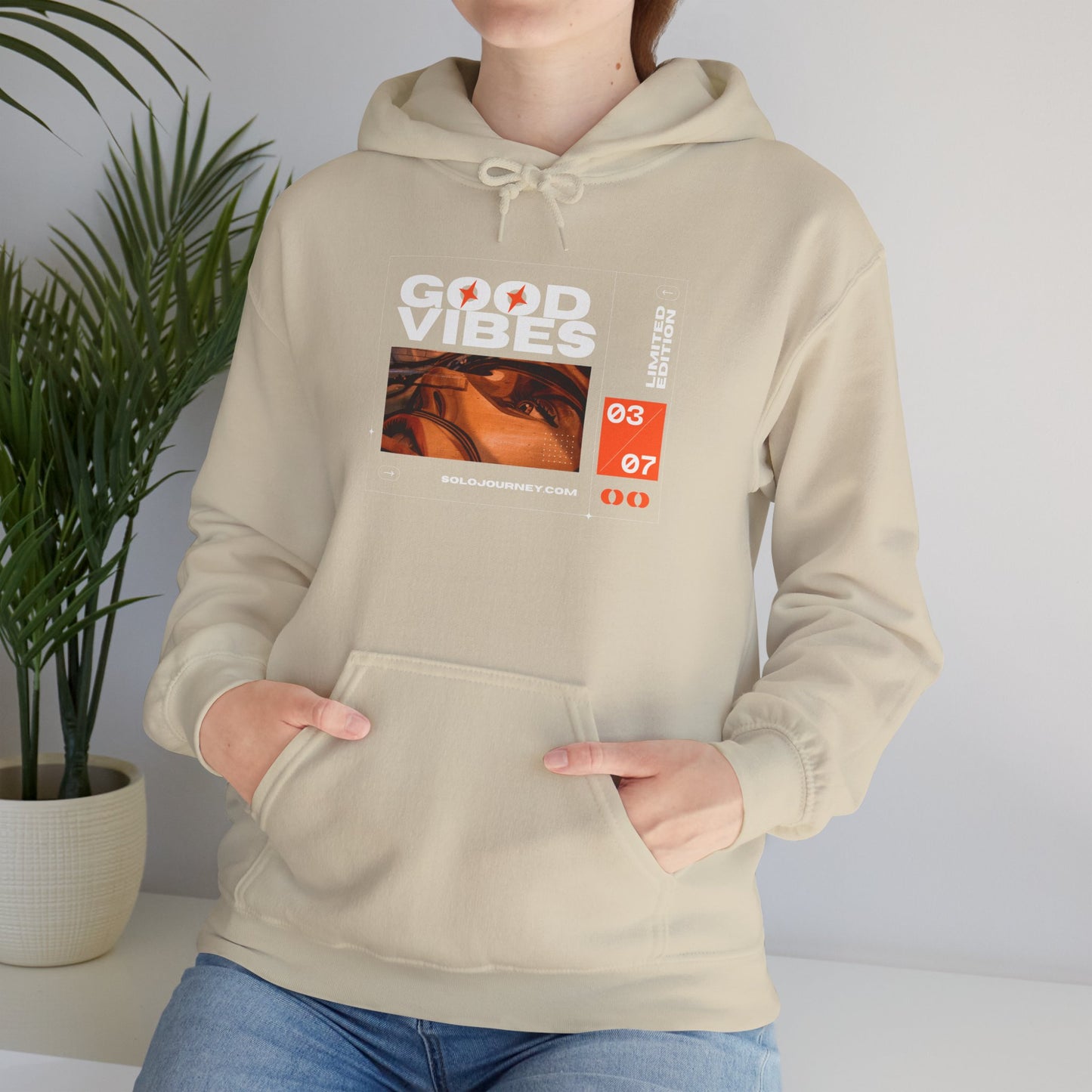 Good Vibes Unisex Heavy Blend Hoodie in a stylish setup, showcasing eco-friendly organic cotton sweatshirt for comfort and style.