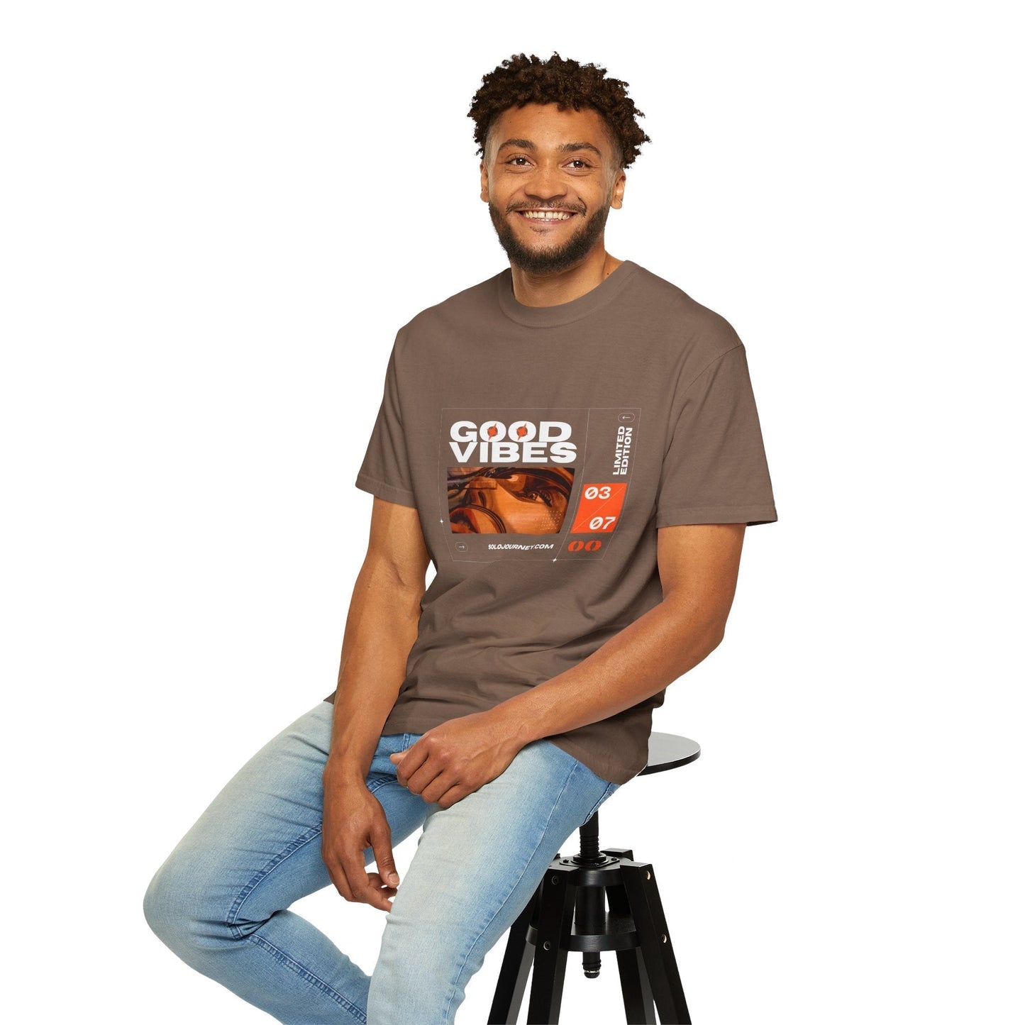 Good Vibes Graphic Design Pullover hanging comfortably in a bright, airy space, illustrating its lightweight fabric and boho style for eco-conscious fashion lovers.