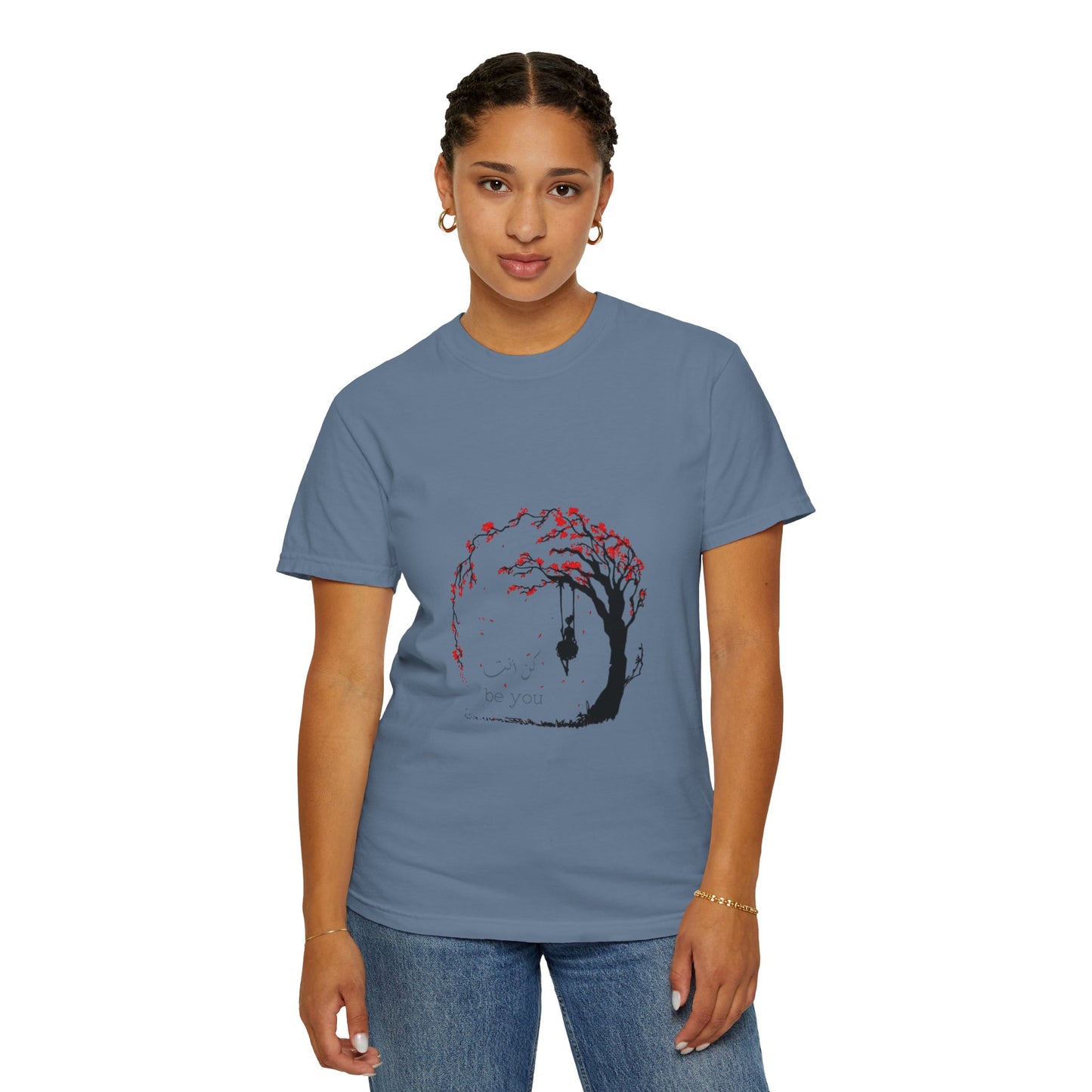 The Cherry Blossom Unisex T-Shirt draped over a stylish outfit, emphasizing its compatibility with casual and chic looks.