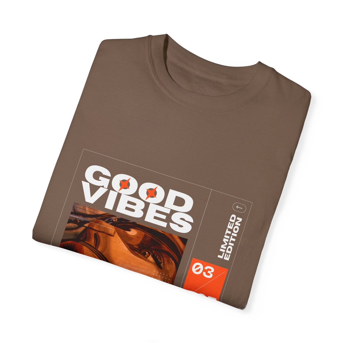 Good Vibes Graphic Design Pullover - Vintage Boho Oversized T-Shirt in Organic Cotton laid flat on a stylish surface, emphasizing its relaxed silhouette and eco-friendly appeal.