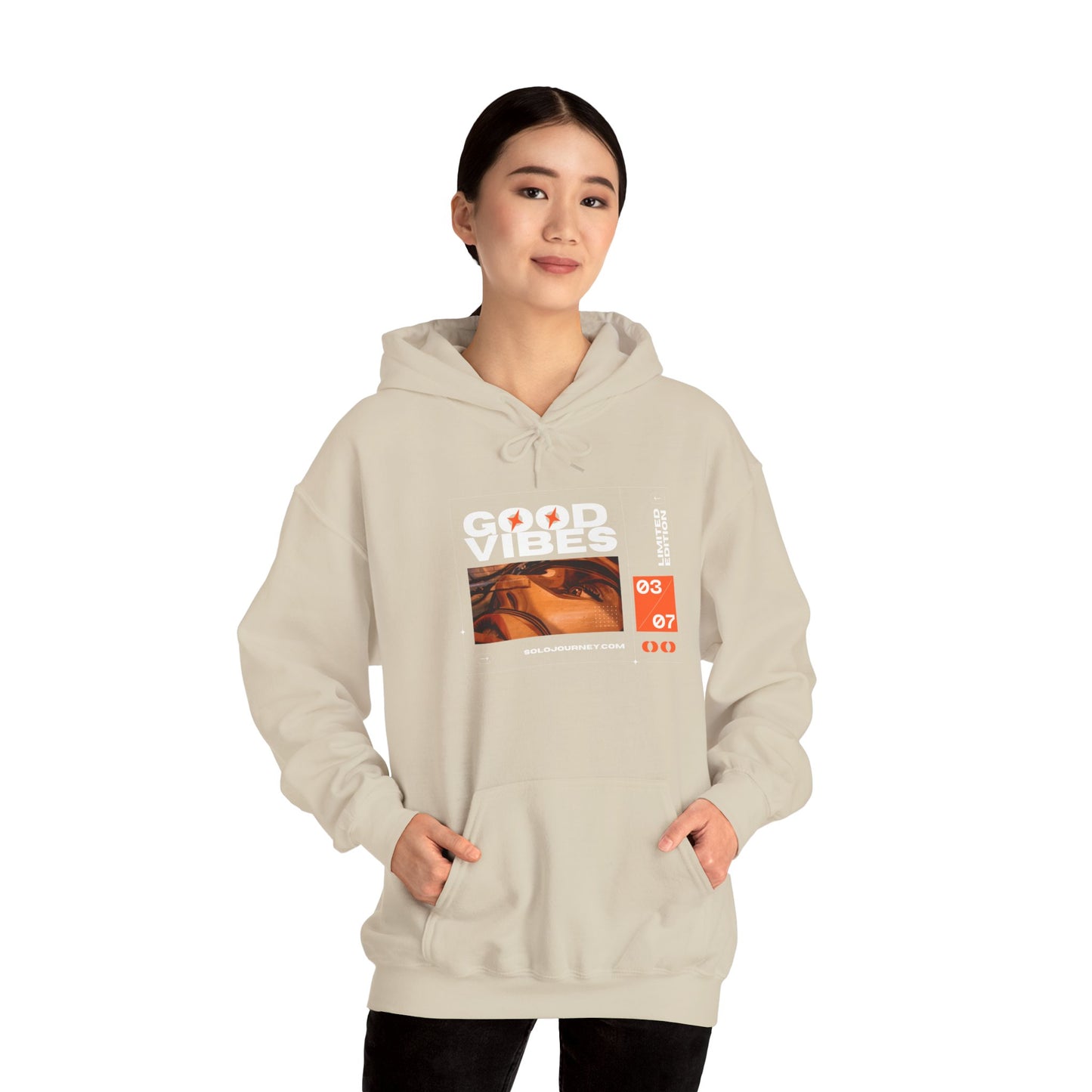 Comfortable Good Vibes Unisex Heavy Blend Hoodie styled with jeans for a laid-back look.
