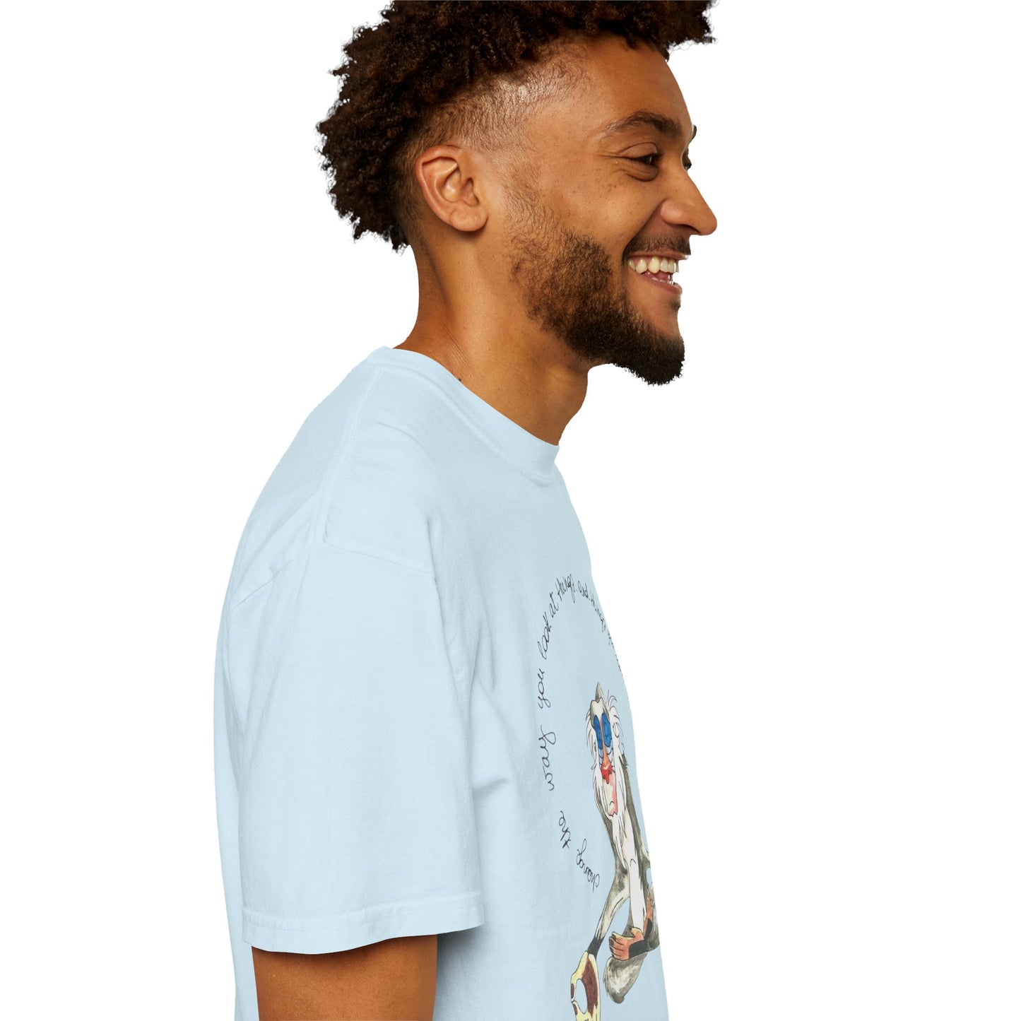 The eco-friendly Monkey Legend Graphic Art Oversized Boho Pullover Tee displayed on a hanger, emphasizing its vibrant graphic print and sustainable material.