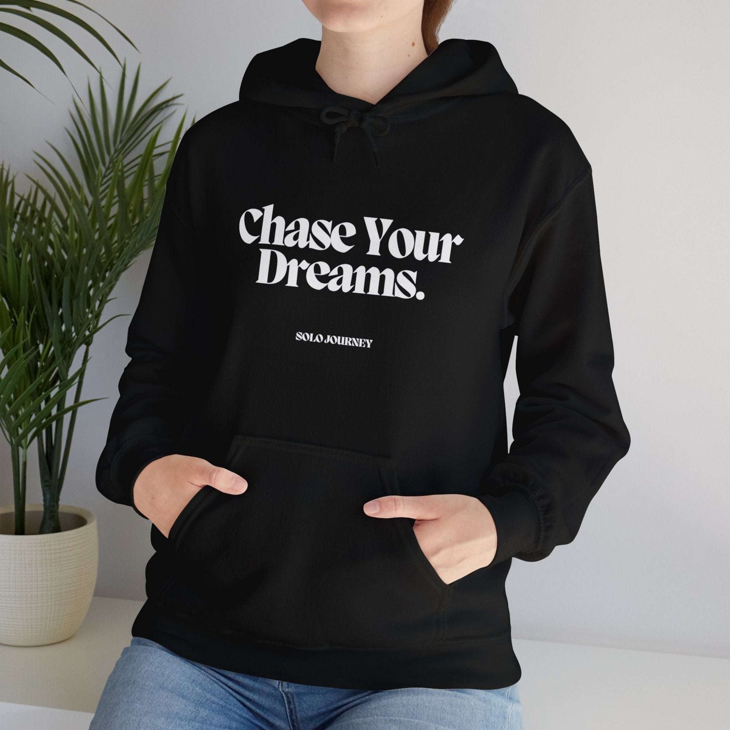 Chase Your Dreams Hoodie styled with jeans, showcasing its relaxed fit and motivational message, perfect for comfortable and chic everyday wear.