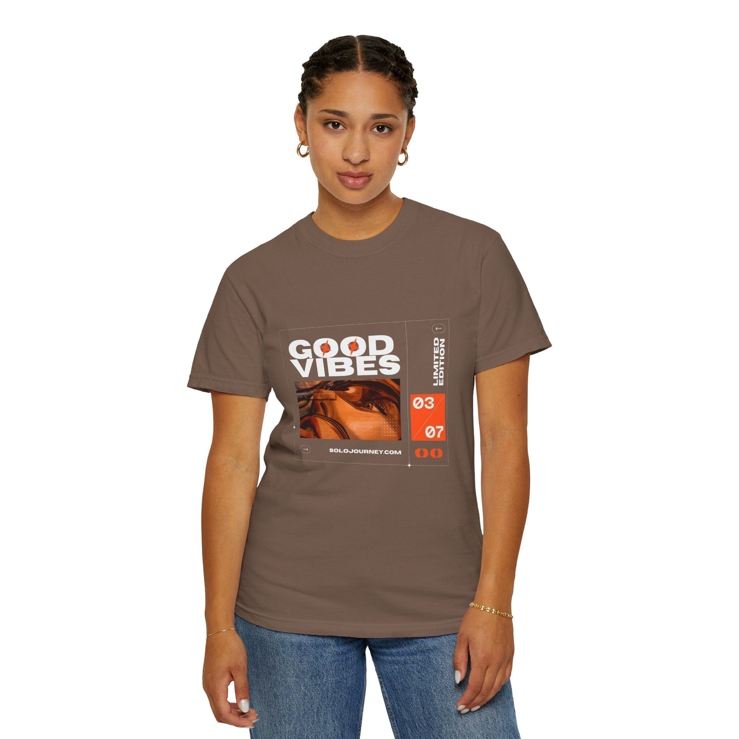 Good Vibes Graphic Design Pullover - Vintage Boho Oversized T-Shirt in Organic Cotton displayed on a wooden hanger against a rustic background, showcasing its relaxed fit and unique graphic print.
