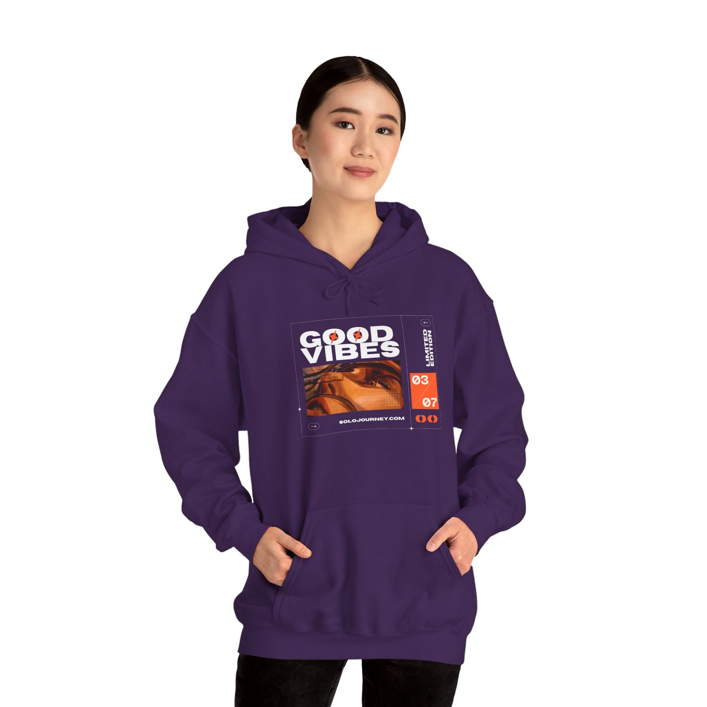 Model wearing Good Vibes Unisex Heavy Blend Hoodie in an urban setting, combining style with sustainability.