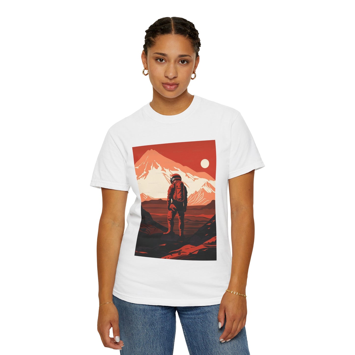 Flat lay of the Man On Mars Graphic T-Shirt on a textured surface, focusing on the organic cotton fabric and bold graphic designs.